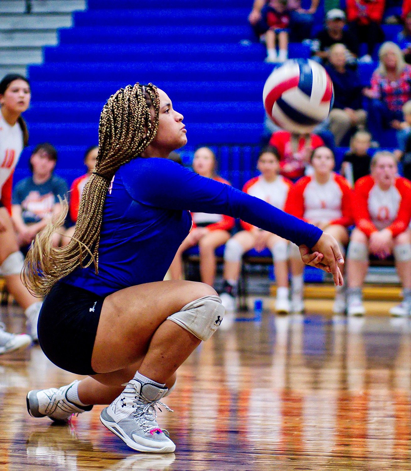 Mineola libero Paris Spigner gets low for the dig. [view more volleyball shots]